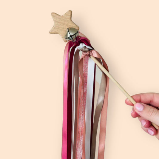 wooden wand with bells and ribbons
